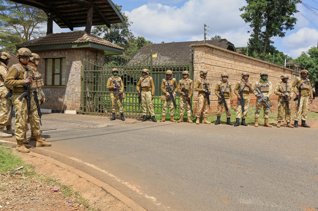 Kenya Wildlife Service security personnel stand at the entrance to Nairobi National Park during a protest over plans affecting the park in Nairobi, Kenya, Monday, June 8, 2026. (AP Photo/Andrew Kasuku)