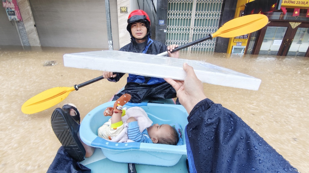 A baby is evacuated from flood in Khanh Hoa, Vietnam Thursday, Nov. 20, 2025. (Nguyen Huy Thanh/VNA via AP)