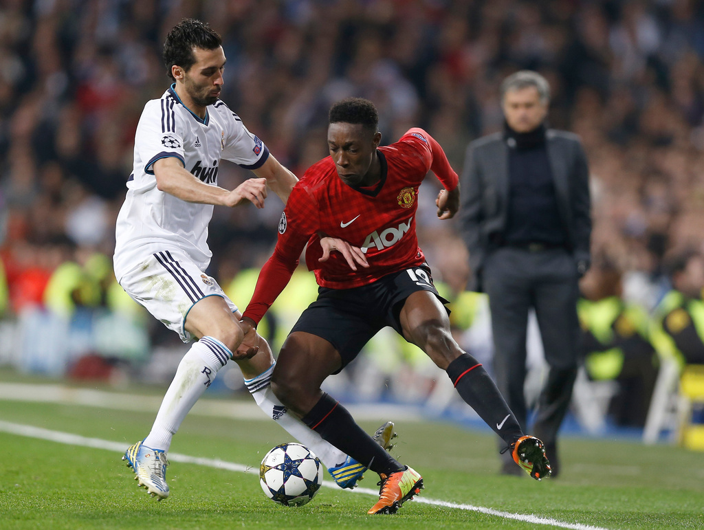 FILE - Real Madrid's Alvaro Arbeloa, left, fights for the ball with Manchester United's Danny Welbeck, with Real Madrid coach Jose Mourinho on the background, during the Champions League round of 16 first leg soccer match between Real Madrid and Manchester United at the Santiago Bernabeu stadium in Madrid, Wednesday Feb. 13, 2013. (AP Photo/Daniel Ochoa de Olza, File)