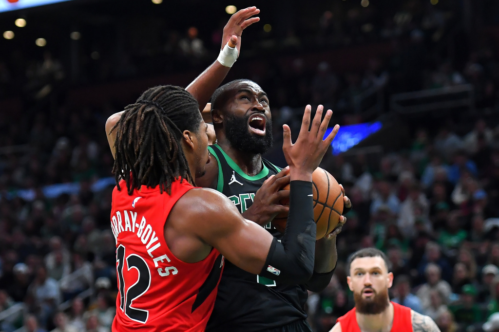 Boston Celtics guard Jaylen Brown drives toward the basket as Toronto Raptors forward Collin Murray-Boyles, left, defends in the second half of an NBA basketball game, Sunday, April 5, 2026, in Boston. (AP Photo/Steven Senne)