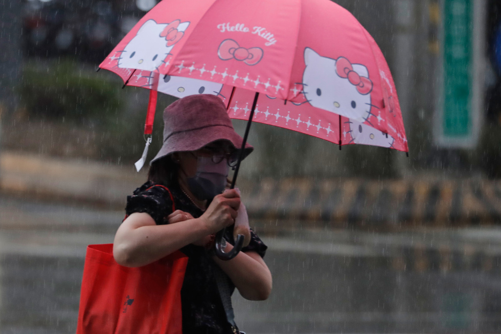 People walk in the rain caused by typhoon Ragasa in Taipei, Taiwan Tuesday, Sept. 23, 2025. (AP Photo/Chiang Ying-ying)