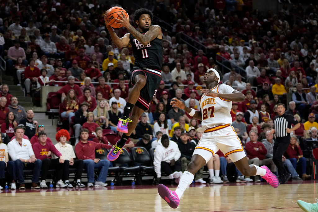 Texas Tech guard Jaylen Petty (11) passes over Iowa State guard Killyan Toure (27) during the first half of an NCAA college basketball game, Saturday, Feb. 28, 2026, in Ames, Iowa. (AP Photo/Charlie Neibergall)