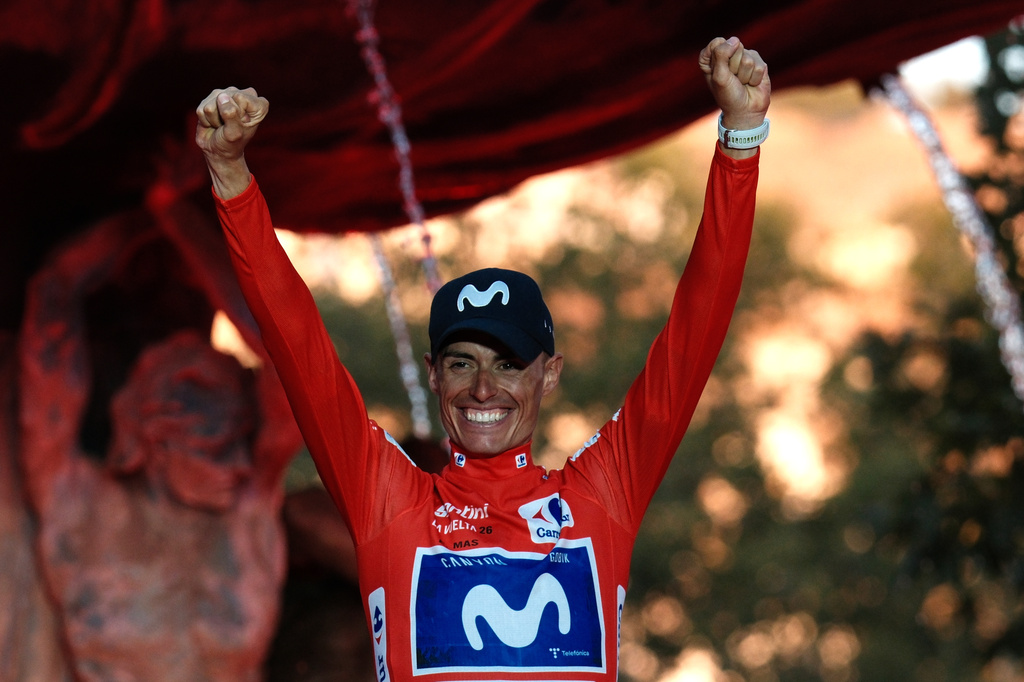 Spain's Enric Mas celebrates on the podium after winning the overall classification of the Spanish Vuelta cycling race in Granada, Spain, Sunday, Sept. 13, 2026. (AP Photo/Gregorio Marrero)