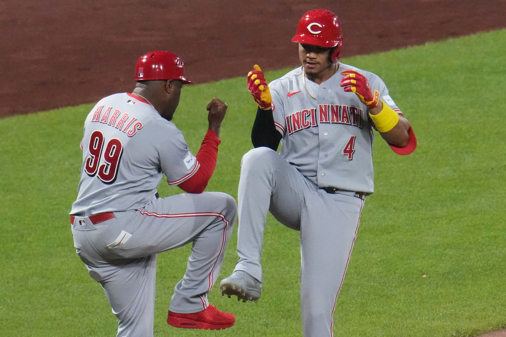 Cincinnati Reds' Noelvi Marte (4) celebrates with Cincinnati Reds third base coach Willie Harris (99) as he rounds third base after hitting a two-run home run off Pittsburgh Pirates pitcher Mason Montgomery during the eighth inning of a baseball game in Pittsburgh, Friday, June 26, 2026. (AP Photo/Gene J. Puskar)