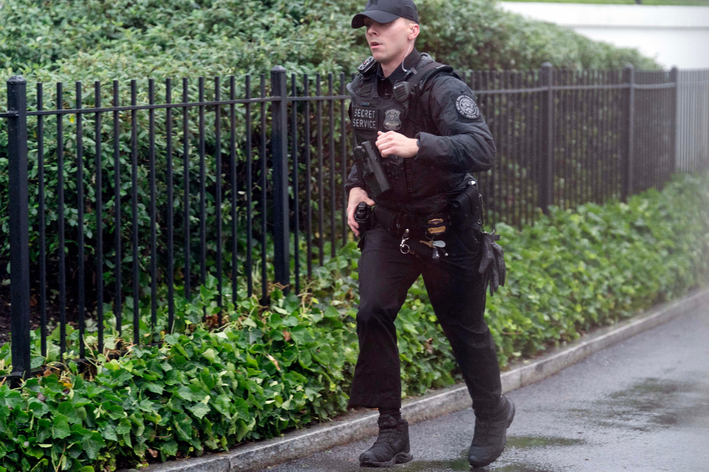 A secret service police officer runs at the White House, Saturday, May 23, 2026, in Washington. (AP Photo/Jose Luis Magana)