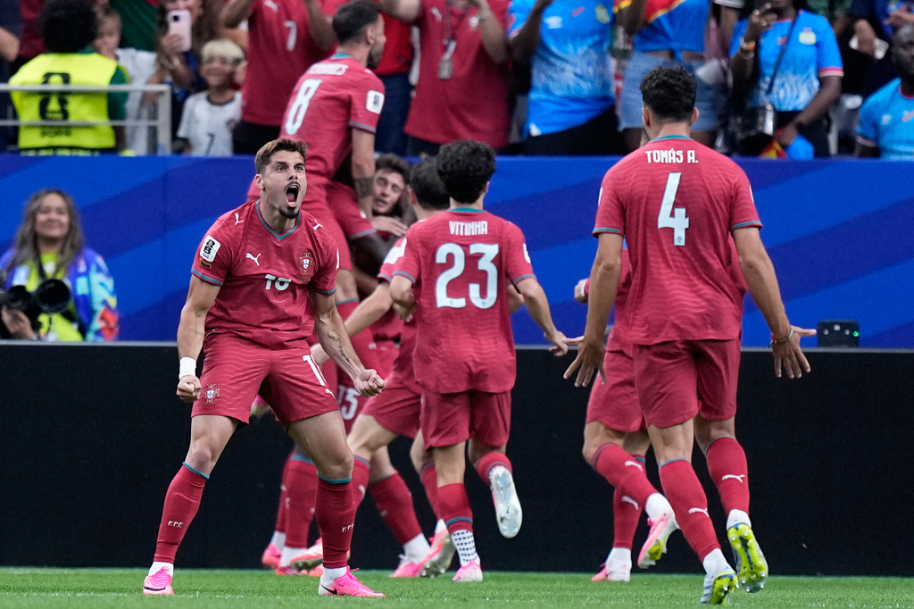 Portugal's Pedro Neto, left, celebrates after teammate Joao Neves scored the opening goalduring the World Cup Group K soccer match between Portugal and Congo in Houston, Wednesday, June 17, 2026. (AP Photo/Ashley Landis)