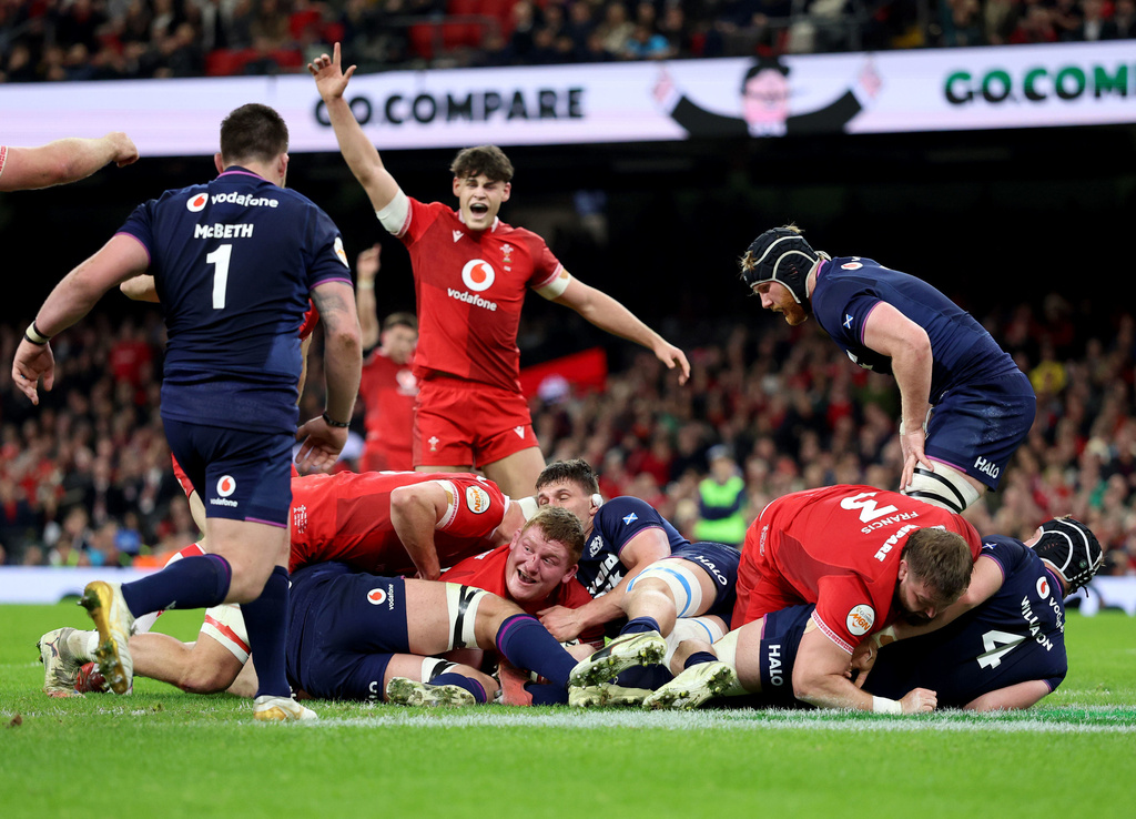 Wales' Rhys Carre, center, celebrates scoring during the Six Nations rugby union match between Wales and Scotland in Cardiff, Wales, Saturday Feb. 21, 2026. (Nigel French/PA via AP)