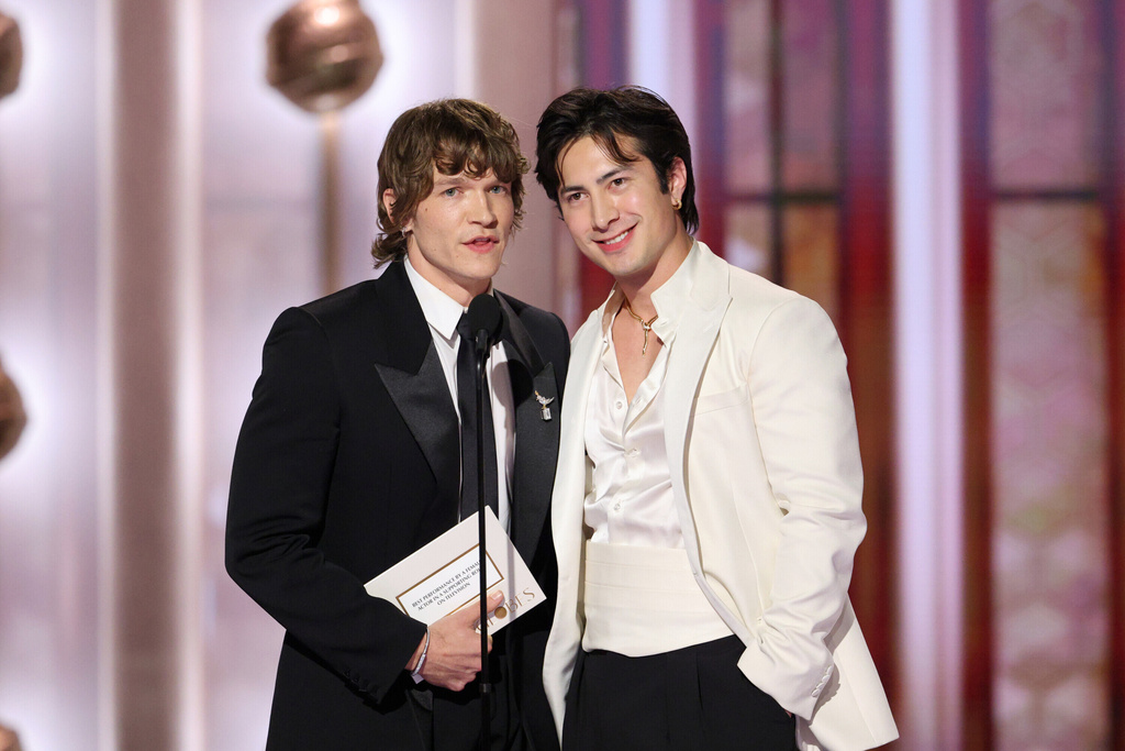 This image released by CBS Broadcasting shows presenters Connor Storrie and Hudson Williams, right, during the 83rd Golden Globes on Sunday, Jan. 11, 2026, at the Beverly Hilton in Beverly Hills, Calif. (Kevork Djansezian/CBS Broadcasting via AP)
