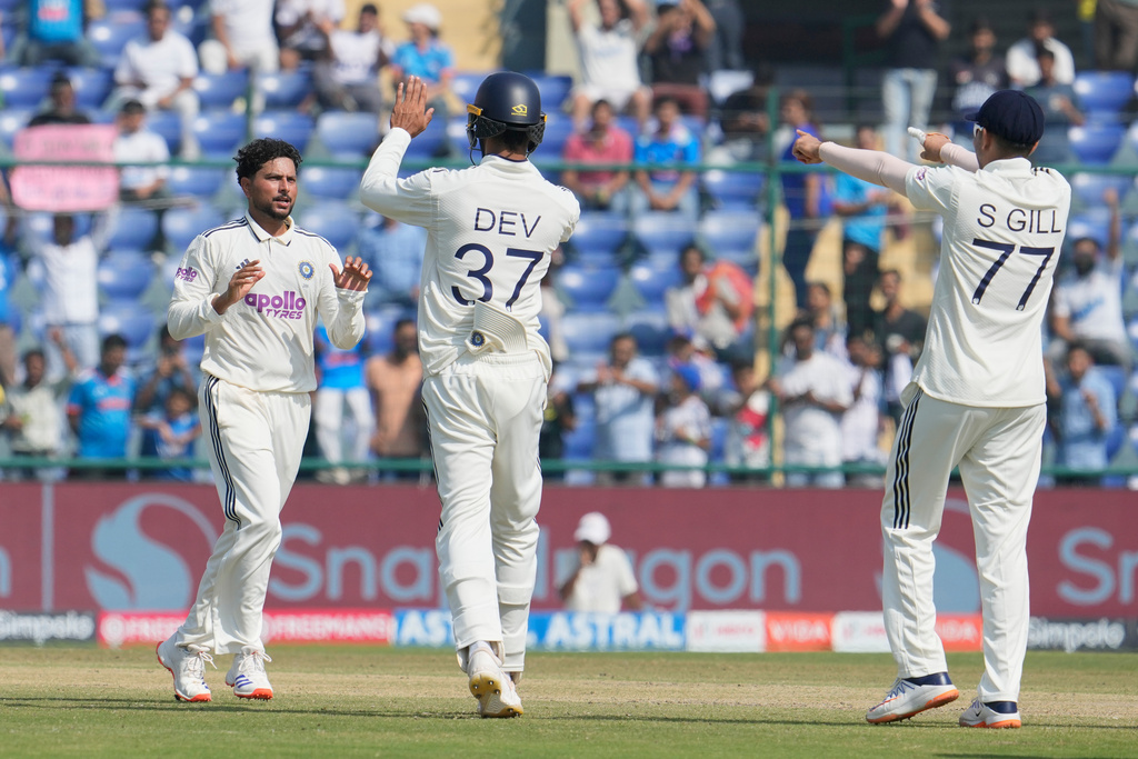 India's Kuldeep Yadav, left, celebrates the dismissal of West Indies' Justin Greaves with teammates on the third day of the second cricket test match between India and West Indies at the Arun Jaitley Stadium in New Delhi, India, Sunday, Oct.12, 2025. (AP Photo/Manish Swarup)