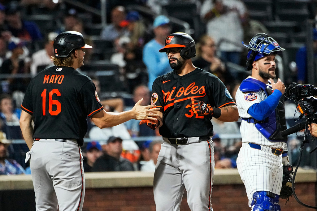 Baltimore Orioles Christian Encarnacion-Strand (32) celebrates with teammate Coby Mayo (16) after hitting a two-run home run during the third inning of a baseball game against the New York Mets, Wednesday, Sept. 16, 2026, in New York. (AP Photo/Eduardo Munoz Alvarez)