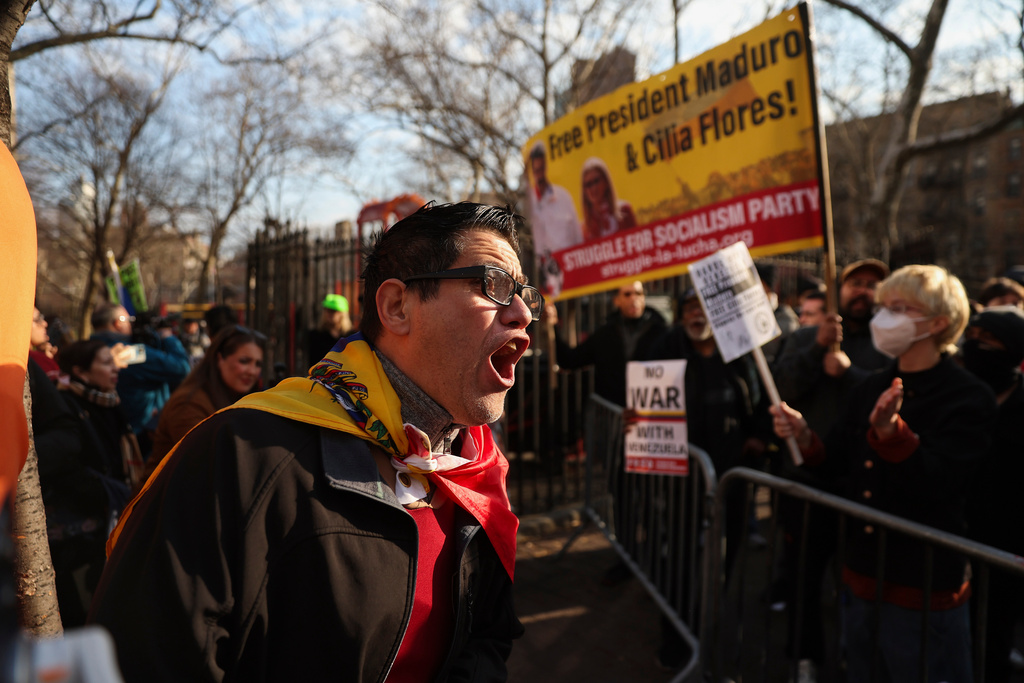 Demonstrators protest outside Manhattan federal court before a pre-trial hearing in former Venezuela President Nicolas Maduro's drug trafficking case, Thursday, March 26, 2026, in New York. (AP Photo/Heather Khalifa)