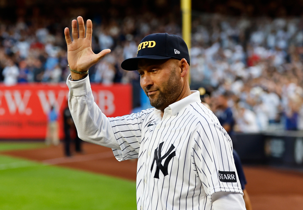 Former New York Yankee Derek Jeter acknowledges fans during a 9/11 ceremony before a baseball game against the New York Mets, Friday, Sept. 11, 2026, in New York. (AP Photo/Noah K. Murray)
