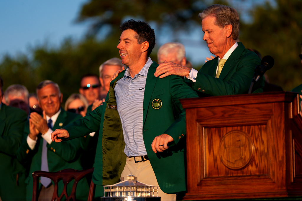 Augusta National Golf Club chairman Fred Ridley puts the green Jacket on Rory McIlroy, of Northern Ireland, after the Masters golf tournament at the Augusta National Golf Club, Sunday, April 12, 2026, in Augusta, Ga.(AP Photo/Ashley Landis)