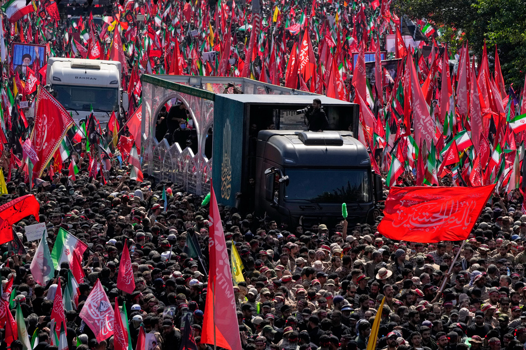 The truck carrying the coffin of the slain Iranian Supreme Leader Ayatollah Ali Khamenei and members of his family. makes its way along an avenue during the funeral procession in Tehran, Iran, Monday, July 6, 2026. (AP Photo/Vahid Salemi) ADDITION - adds that the truck carries also the coffins of other members of his family