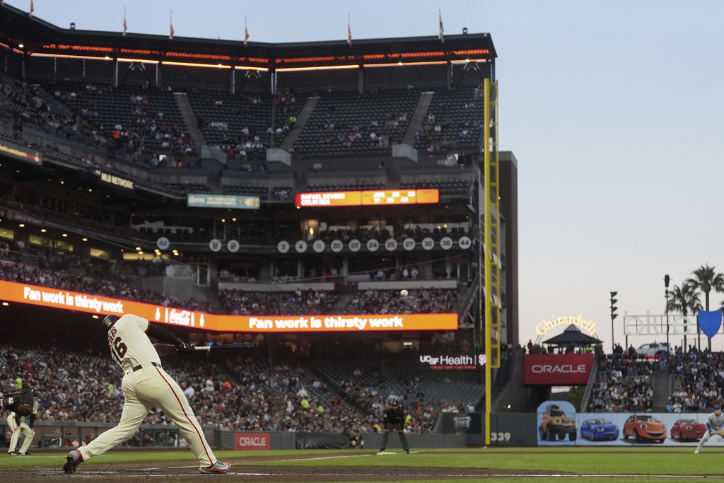 San Francisco Giants' Rafael Devers hits an RBI ground-rule double during the third inning of a baseball game against the Chicago Cubs in San Francisco, Wednesday, Aug. 27, 2025. (AP Photo/Jeff Chiu)