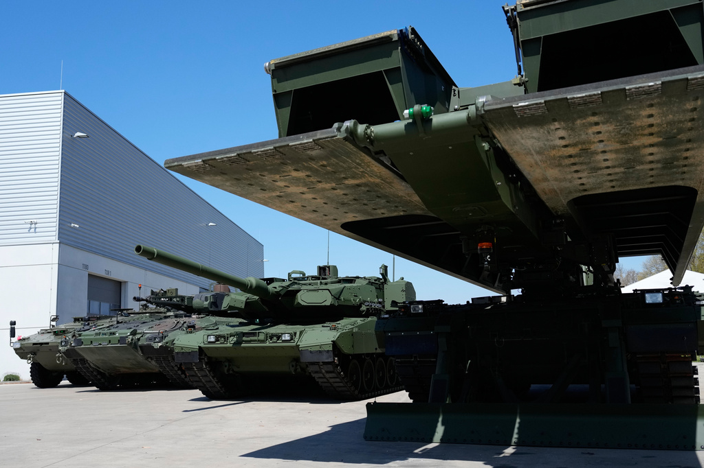 FILE - A boxer armoured personnel carrier, from left, a Puma infantry fighting vehicle and a Leopard battle tank are displayed during the opening of a new production line production line of Boxer 8x8 wheeled armoured personnel carrier produced by pan-European defense company KNDS in Munich, Germany, on April 22, 2026. (AP Photo/Matthias Schrader, File)