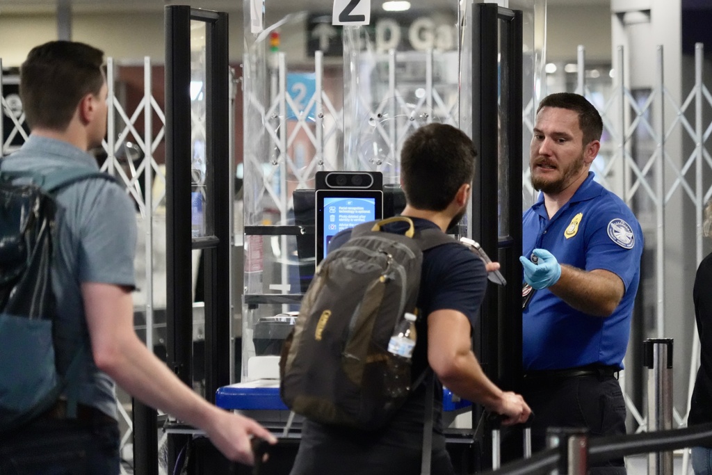 A TSA staff member at a check point at Harry Reid International Airport, Saturday, March 21, 2026, in Las Vegas. (AP Photo/Ty ONeil)