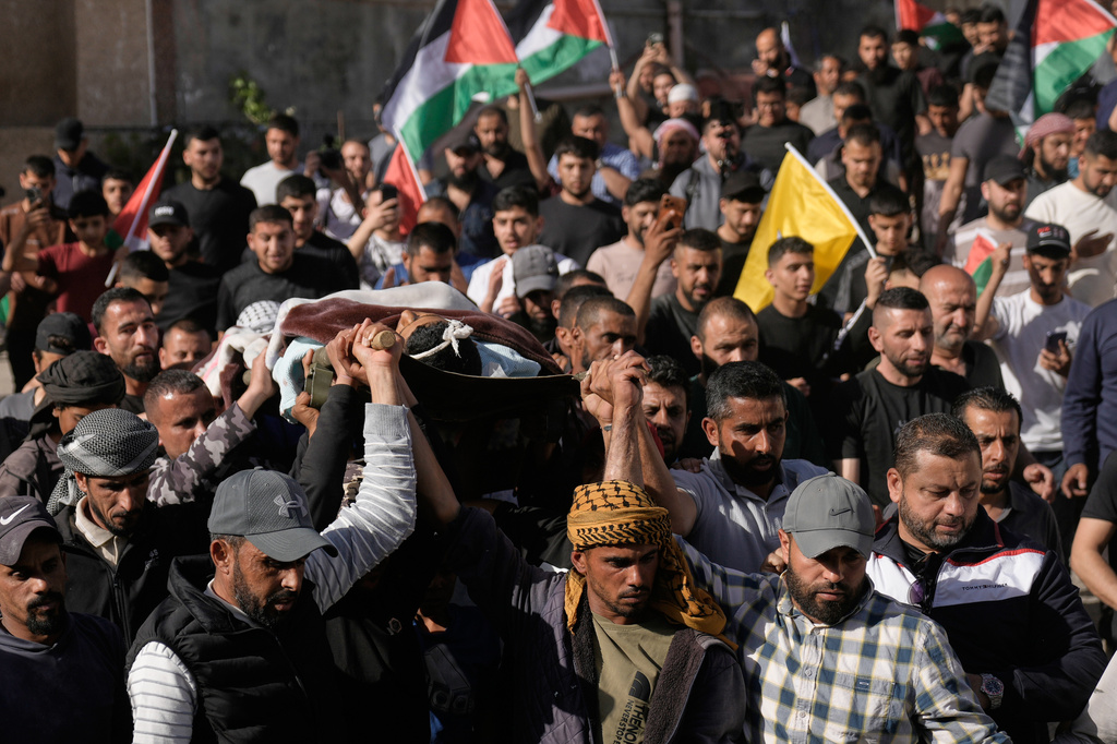 Mourners carry the body of Yousef Ka'abnah, 16, who was killed by Israeli army fire earlier today, during his funeral in West Bank village of al-Lubban al-Sharqiya, Wednesday, May 13, 2026. (AP Photo/Majdi Mohammed)