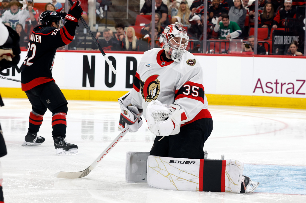 Ottawa Senators goaltender Linus Ullmark (35) looks past toward the net as Carolina Hurricanes' Logan Stankoven (22) celebrates his goal during the second period of an Game 1 of an NHL hockey Stanley Cup first-round playoff series in Raleigh, N.C., Saturday, April 18, 2026. (AP Photo/Karl DeBlaker)
