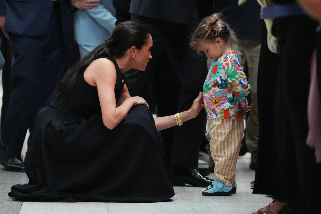 Meghan Markle, the Duchess of Sussex, meets a young child during a visit to the Royal Children's Hospital Melbourne, Australia Tuesday, April 14, 2026. (Jonathan Brady/Pool Photo via AP)