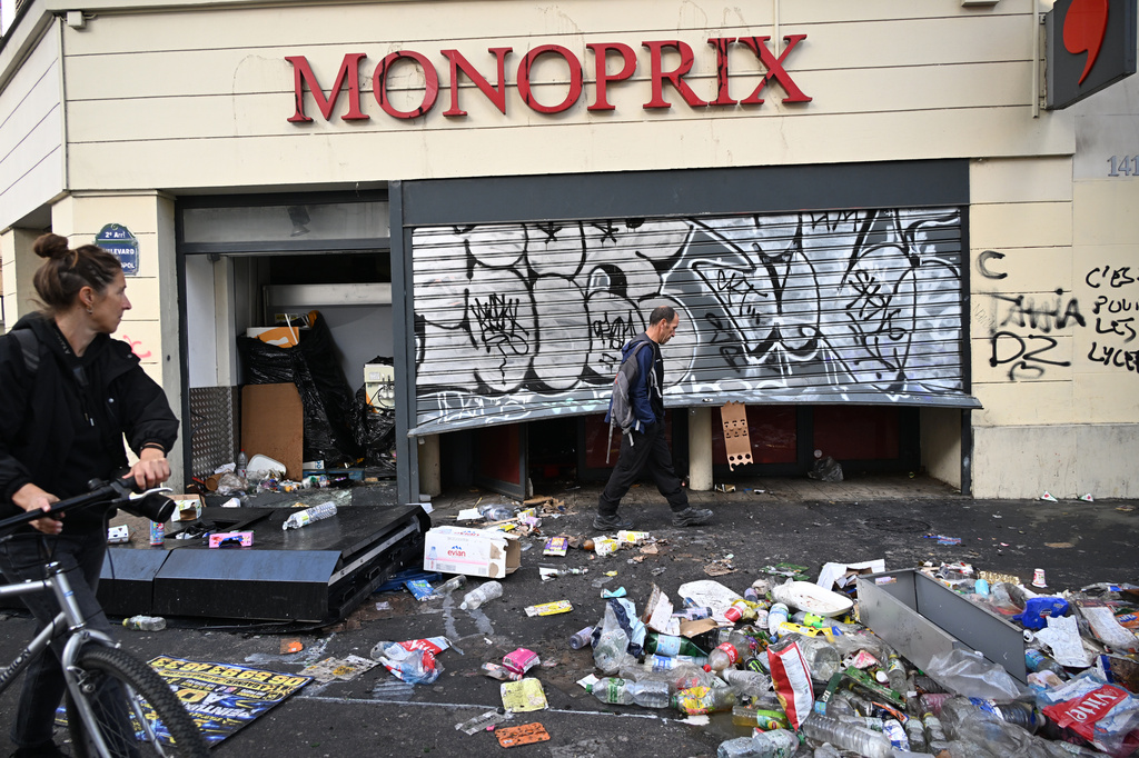 A man walks past a looted store the day after a demonstration against rising living costs and in solidarity with students&rsquo; grievances, in Paris, Sunday, Oct. 18, 2026. (AP Photo/Emma Da Silva)