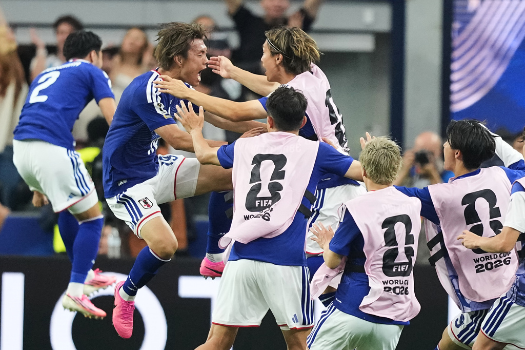 Japan's Koki Ogawa, left, celebrates with teammates their side's second goal against the Netherlands during a World Cup Group F soccer match in Arlington, Texas, near Dallas, Sunday, June 14, 2026. (AP Photo/Julio Cortez)