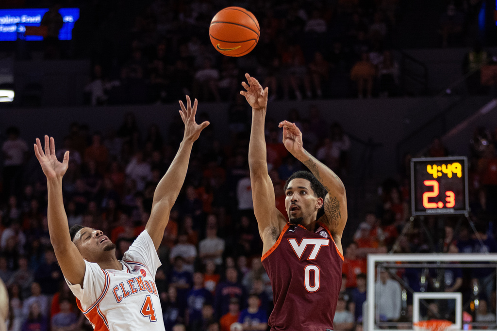 Virginia Tech guard Jailen Bedford (0) shoots the ball against Clemson guard Efrem Johnson (4) during the first half of an NCAA college basketball game Wednesday, Feb. 11, 2026, in Clemson, S.C. (AP Photo/Scott Kinser)