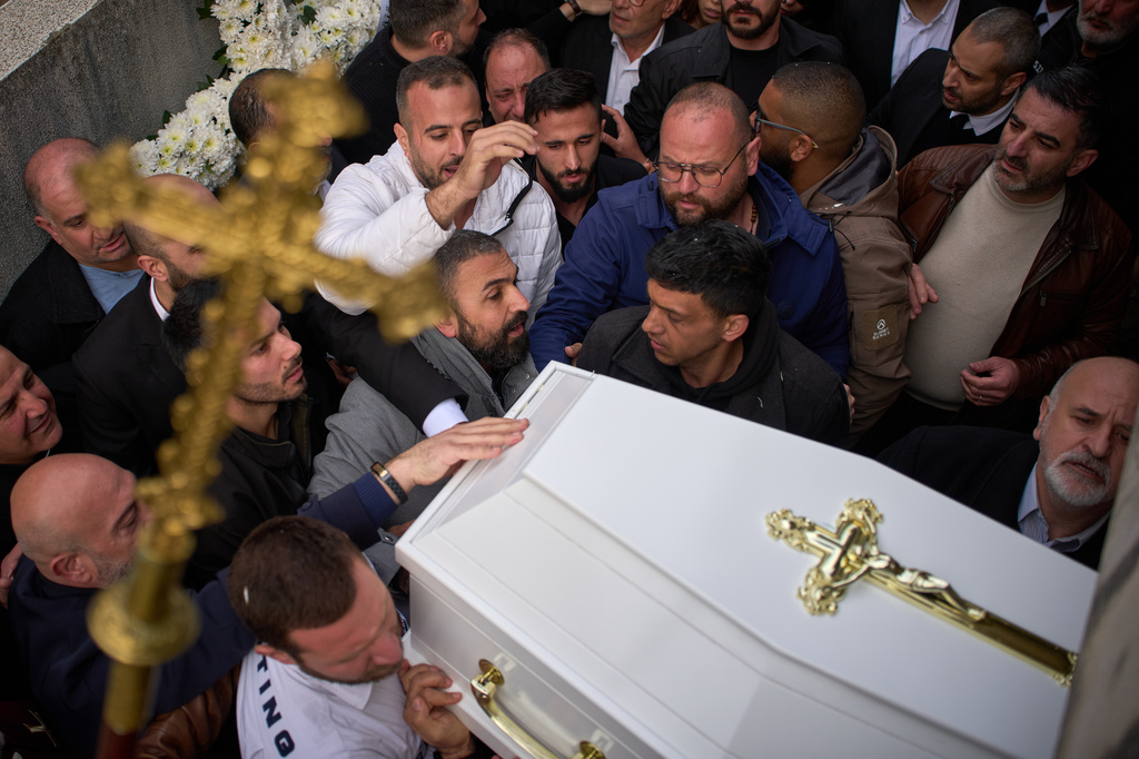 Men carry the coffins with the bodies of Pierre Mouawad, an official with the anti-Hezbollah Lebanese Forces party, and his wife during their funeral in Yahshush, Lebanon, Tuesday, April 7, 2026. (AP Photo/Emilio Morenatti)