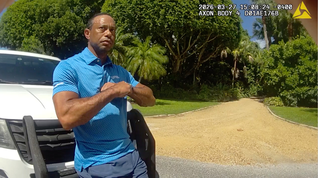 FILE - In this image from police body camera video released by the Martin County, Fla., Sheriff's Office, golfer Tiger Woods performs a field sobriety test for sheriff's deputies following a car crash in Jupiter Island, Fla., March 27, 2026. (Martin County Sheriff's Office via AP, File)
