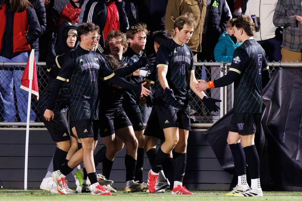 Washington players celebrate after scoring a goal against North Carolina State in the NCAA College Cup National Championship soccer final in Cary, N.C., Monday, Dec. 15, 2025. (AP Photo/Ben McKeown)