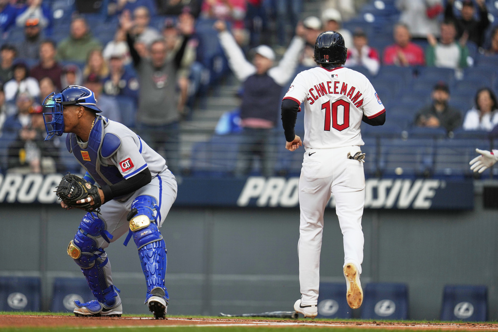 Cleveland Guardians' Daniel Schneemann scores behind Kansas City Royals catcher Salvador Perez, left, on a hit by designated hitter Kyle Manzardo in the first inning of a baseball game in Cleveland, Monday, Sept. 8, 2025. (AP Photo/Sue Ogrocki)