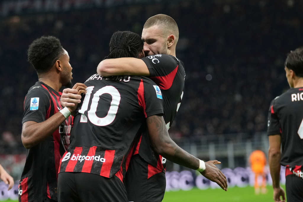 AC Milan's Strahinja Pavlovic, centre right, celebrates with Rafael Leao, centre left, after scoring the opening goal during the Serie A soccer match between AC Milan and Roma in Milan, Italy, Sunday, Nov. 2, 2025. (AP Photo/Antonio Calanni)