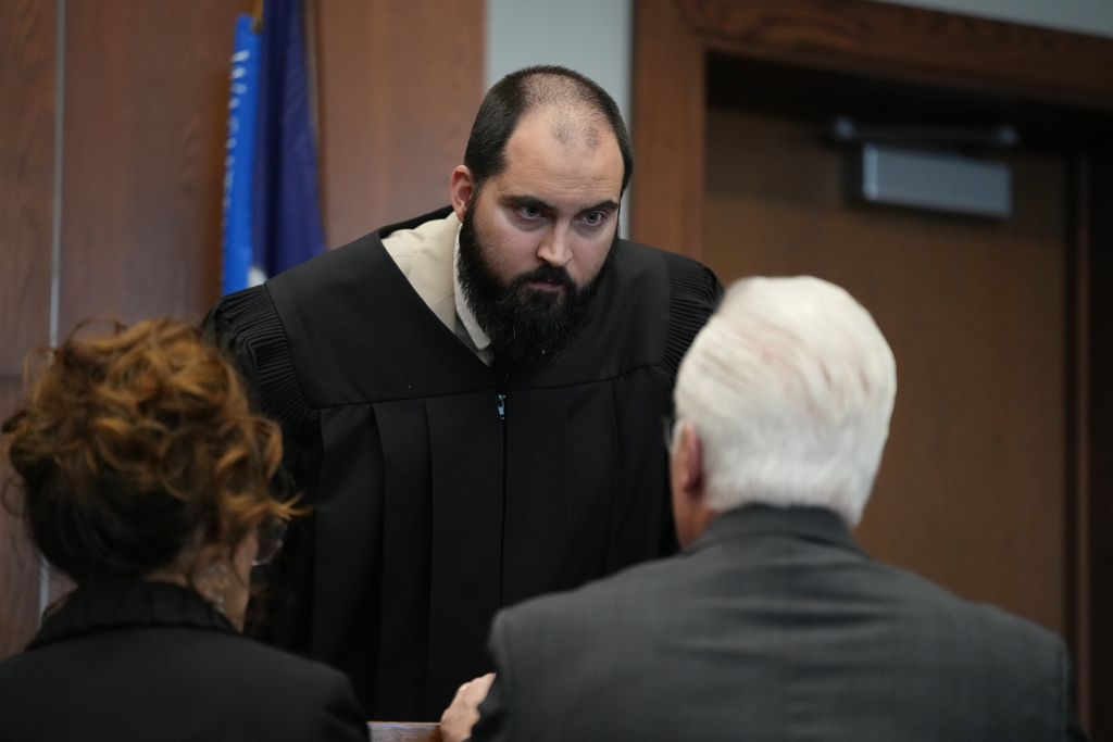 Magistrate Odetalla listens to Michigan football coach Sherrone Moore's attorney Joseph A. Simon and Assistant prosecutor Kati Rezmierski in court on Friday, Dec. 12, 2025 in Ann Arbor, Mich. (AP Photo/Ryan Sun, Pool)