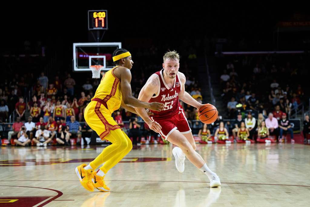 Nebraska forward Rienk Mast (51) drives with the ball while under pressure from Southern California guard Jerry Easter II, left, during the first half of an NCAA college basketball game Saturday, Feb. 28, 2026, in Los Angeles. (AP Photo/William Liang)