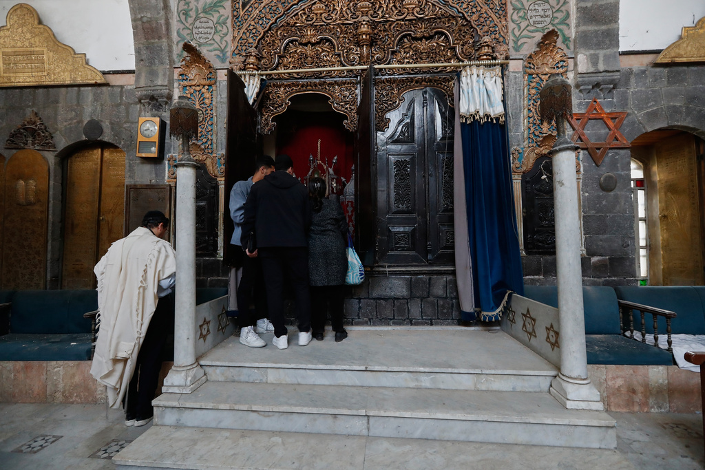 Henry Hamra, left, a Syrian-American Jew who is one of the founders of a new Jewish heritage initiative, and other Jews citizens pray at al-Firenj Synagogue in the old city of Damascus, Syria, Wednesday, Dec. 10, 2025.(AP Photo/Omar Sanadiki)