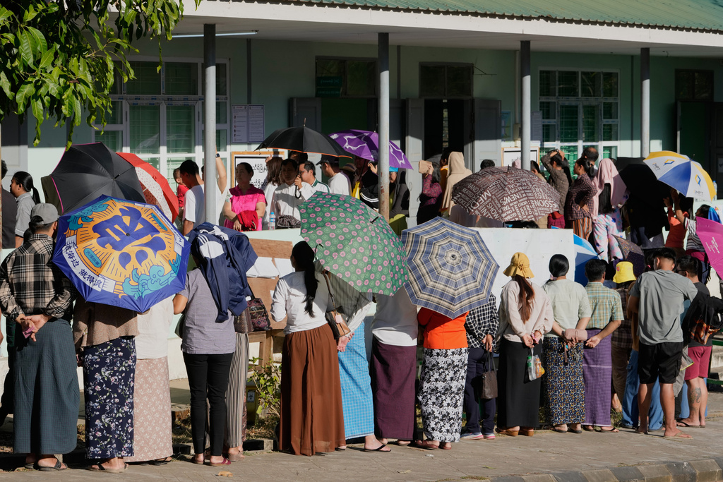 Voters line up to cast their ballots at a polling station, in Naypyitaw, Myanmar, Sunday, Dec. 28, 2025. (AP Photo/Aung Shine Oo)