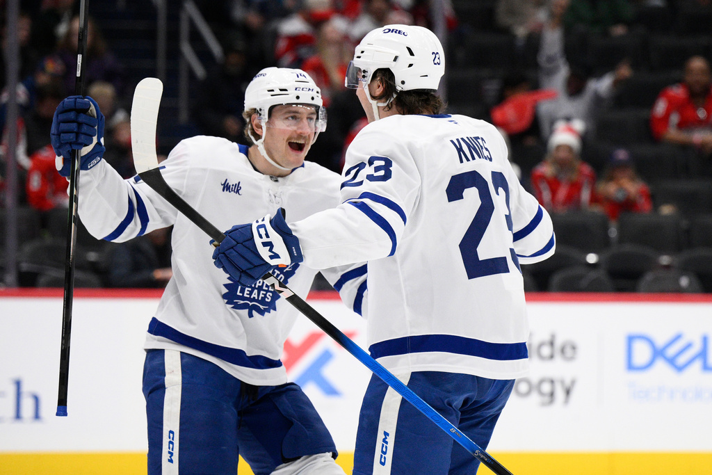Toronto Maple Leafs left wing Matthew Knies (23) celebrates after his goal with center Bobby McMann, left, during the second period of an NHL hockey game against the Washington Capitals, Friday, Nov. 28, 2025, in Washington. (AP Photo/Nick Wass)