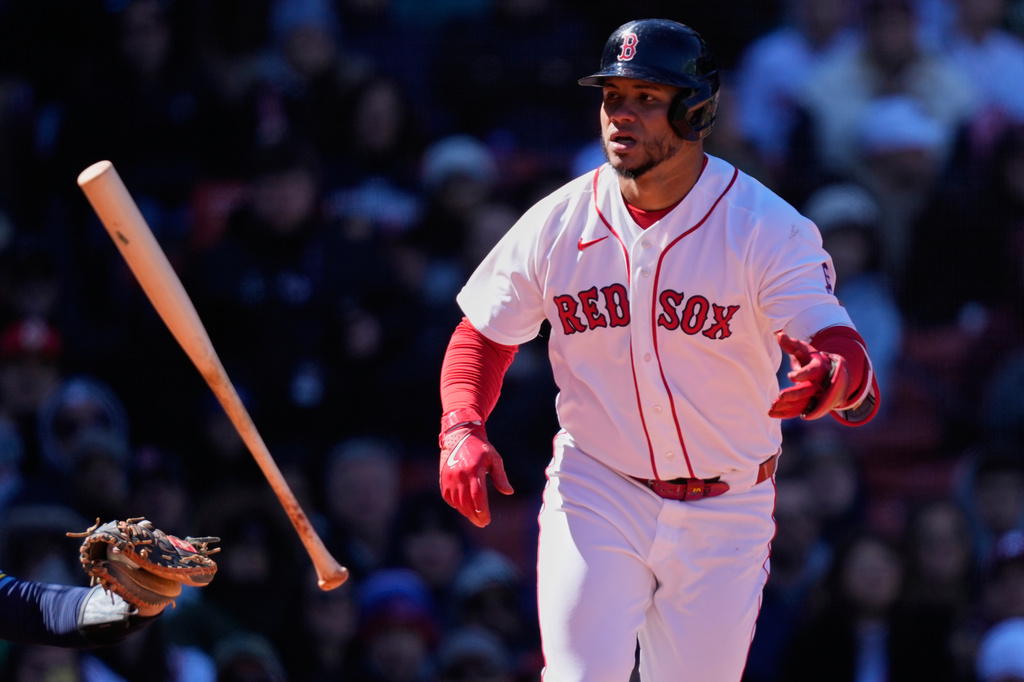 Boston Red Sox's Willson Contreras flips his bat after drawing a bases-loaded walk during the third inning of a baseball game against the Milwaukee Brewers at Fenway Park, Wednesday, April 8, 2026, in Boston. (AP Photo/Charles Krupa)