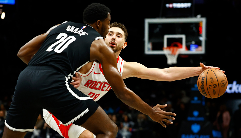 Houston Rockets center Alperen Sengun (28) handles the ball against Brooklyn Nets center Day'Ron Sharpe (20) during the first half of an NBA basketball game, Thursday, Jan. 1, 2026, in New York. (AP Photo/Noah K. Murray)