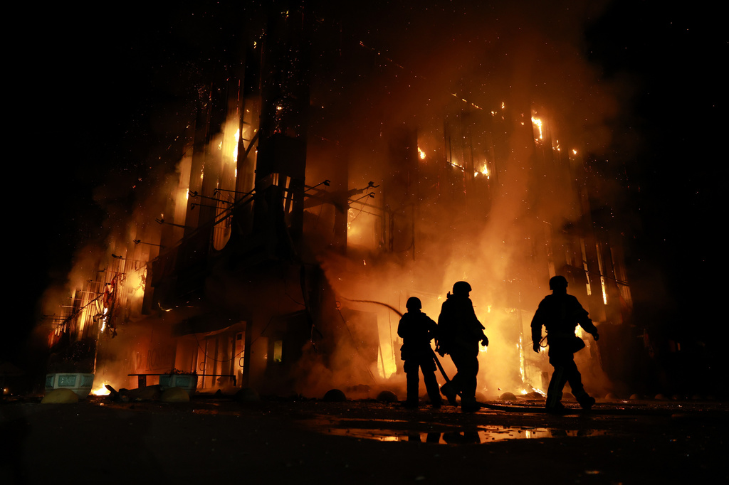 Rescue workers put out a fire at the Intrade trade center after a Russian drone strike on Zaporizhzhia, Ukraine, Monday, Sept. 21, 2026. (AP Photo/Kateryna Klochko) Correction: Byline corrected to Kateryna Klochko, instead of Evgeniy Maloletka