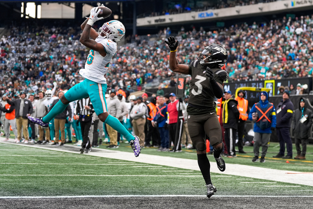 Miami Dolphins cornerback Rasul Douglas (26) intercepts a pass intended for New York Jets wide receiver John Metchie III (3) at the goal line during the second quarter of an NFL football game, Sunday, Dec. 7, 2025, in East Rutherford, N.J. (AP Photo/Yuki Iwamura)