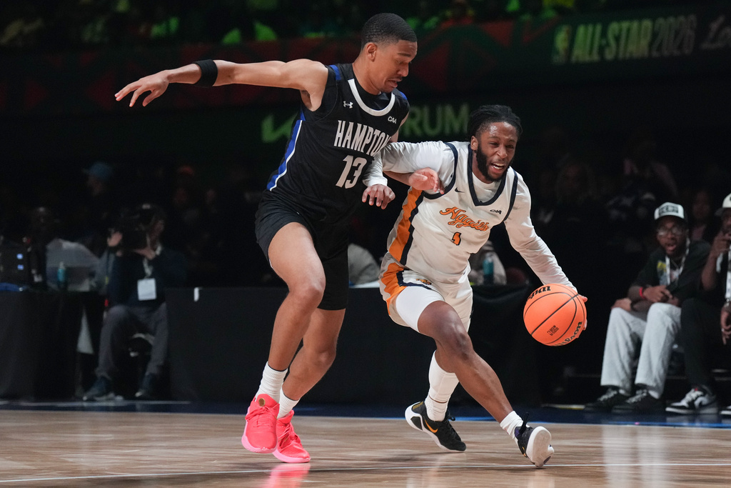 Hampton forward Aidan Haskins (13) pressures North Carolina A&T guard Trent Middleton Jr. (1) during the first half of an HBCU Classic NCAA college basketball game Friday, Feb. 13, 2026, in Inglewood, Calif. (AP Photo/Jae C. Hong)