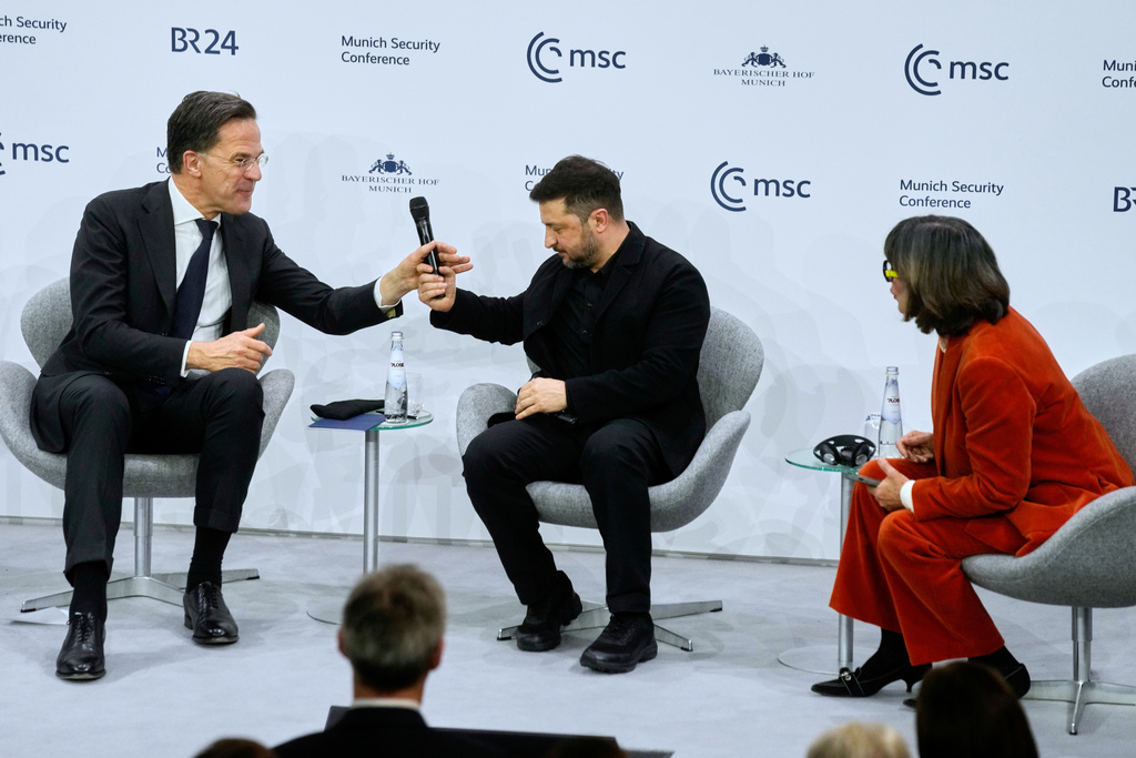 Journalist Christiane Amanpour, right, chairs a panel with Ukraine's President Volodymyr Zelenskyy, center, and NATO Secretary General Mark Rutte at the Munich Security Conference in Munich, Germany, Saturday, Feb. 14, 2026. (AP Photo/Michael Probst)