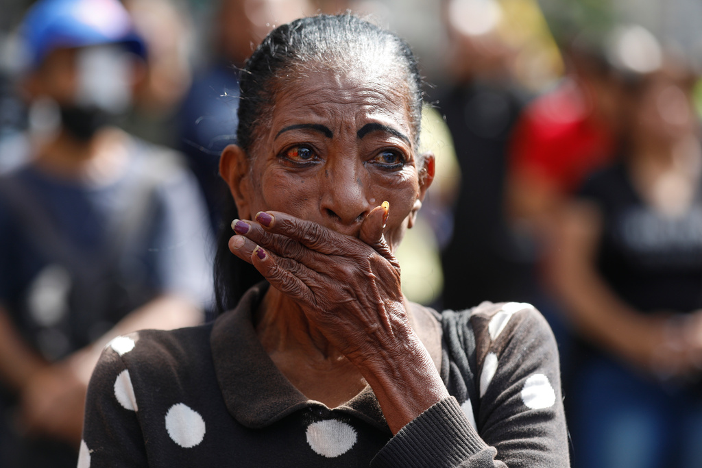 A woman cries during a rally of supporters of Venezuelan President Nicolás Maduro in Caracas, Venezuela, Saturday, Jan. 3, 2026, after U.S. President Donald Trump announced Maduro had been captured and flown out of the country. (AP Photo/Cristian Hernandez)