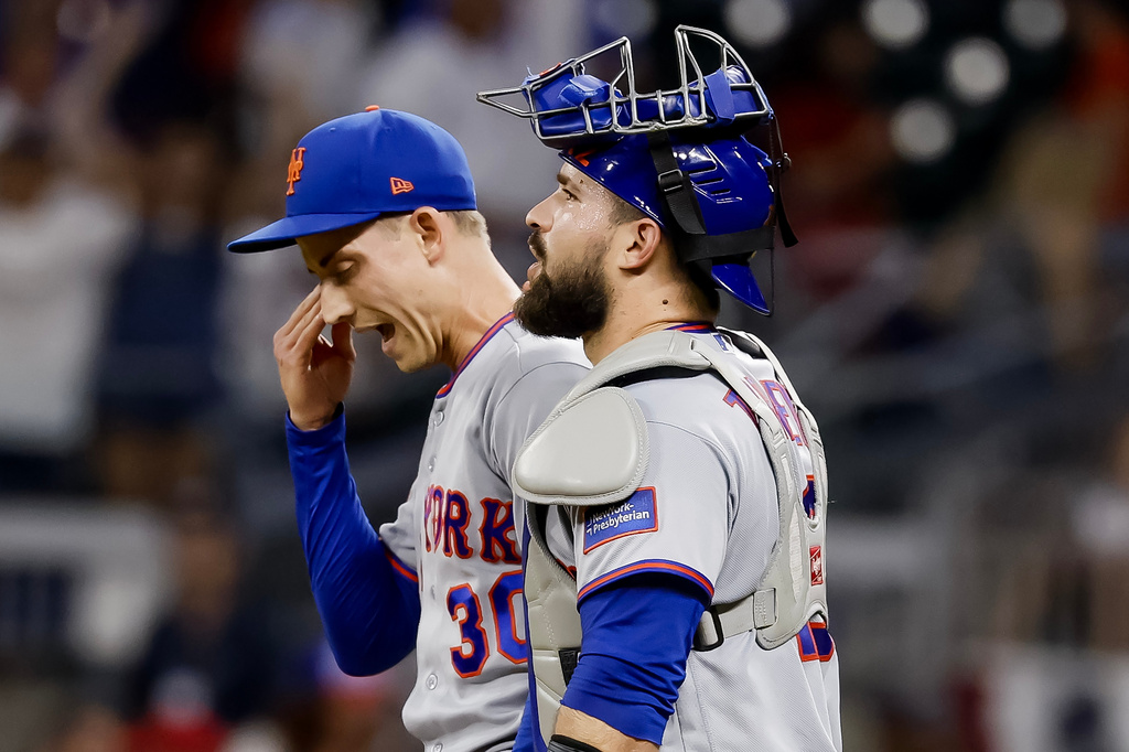 New York Mets pitcher Luke Weaver, left, reacts with catcher Luis Torrens, right, after their team defeated the Atlanta Braves during the 10th inning of a baseball game, Monday, July 6, 2026, in Atlanta. (AP Photo/Erik S. Lesser)