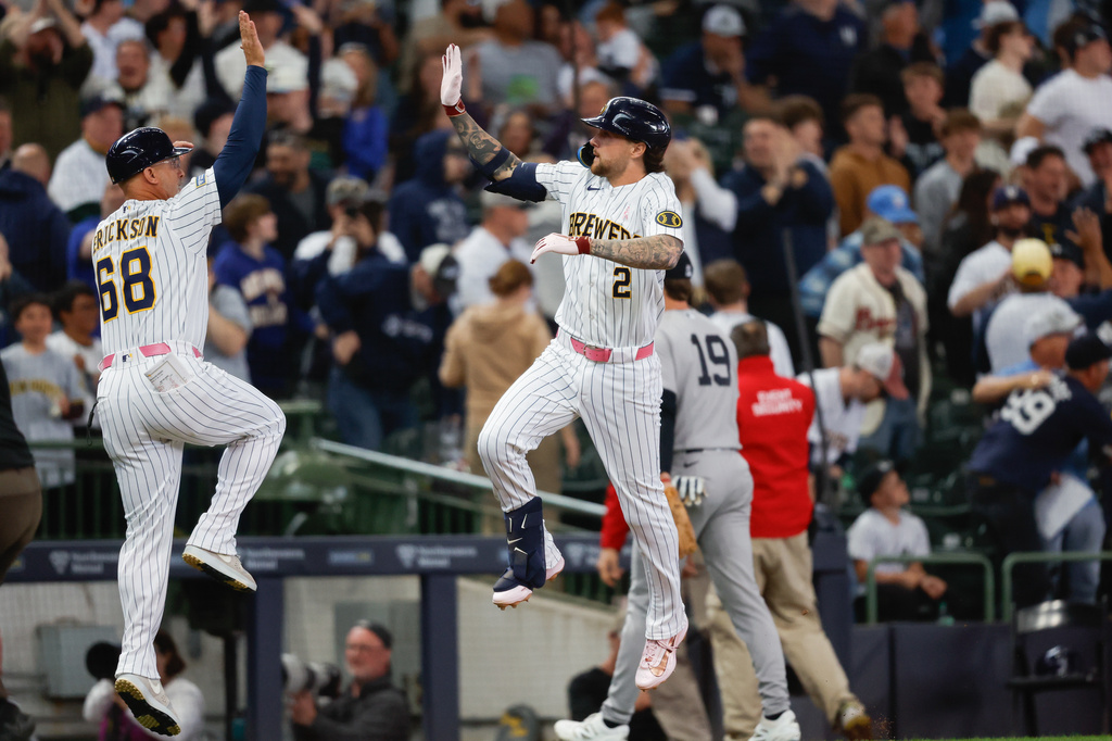 Milwaukee Brewers' Brice Turang (2) gets a high-five after his walk off home run in the ninth inning against the New York Yankees, Sunday, May 10, 2026, in Milwaukee. (AP Photo/Jeffrey Phelps)