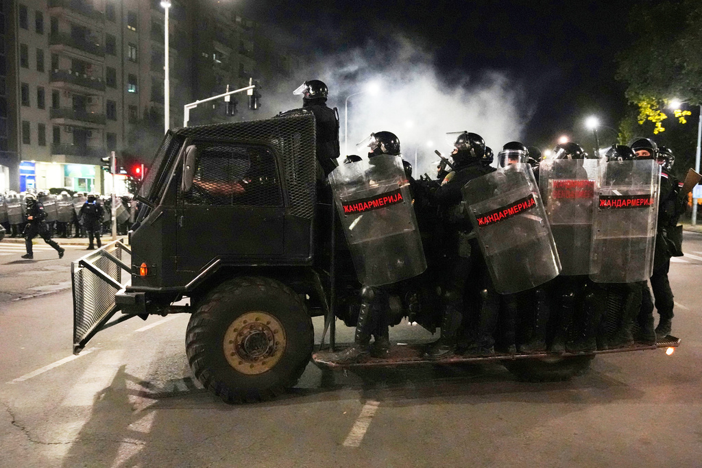 Serbian gendarmerie officers patrol in truck after clearing people blocking a street during an anti-government protest in Belgrade, Serbia, Saturday, Aug. 16, 2025. (AP Photo/Darko Vojinovic)
