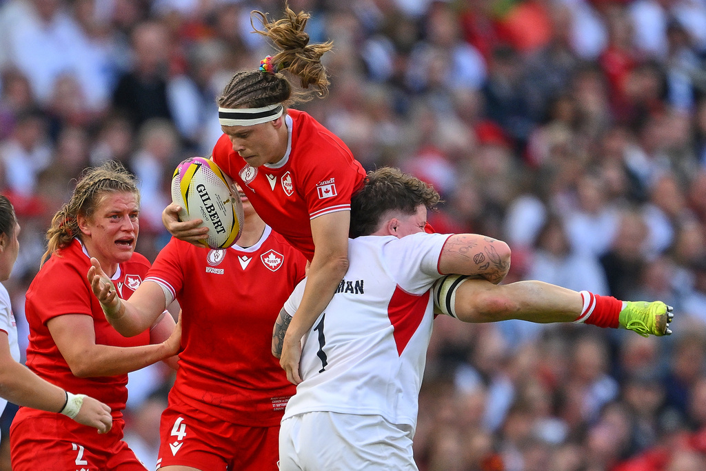 England's Hannah Botterman tackles Canada's Karen Paquin during the Women's Rugby World Cup final match between England and Canada at the Allianz Stadium, Twickenham in London, Saturday, Sept. 27, 2025.(AP Photo/Anthony Upton)