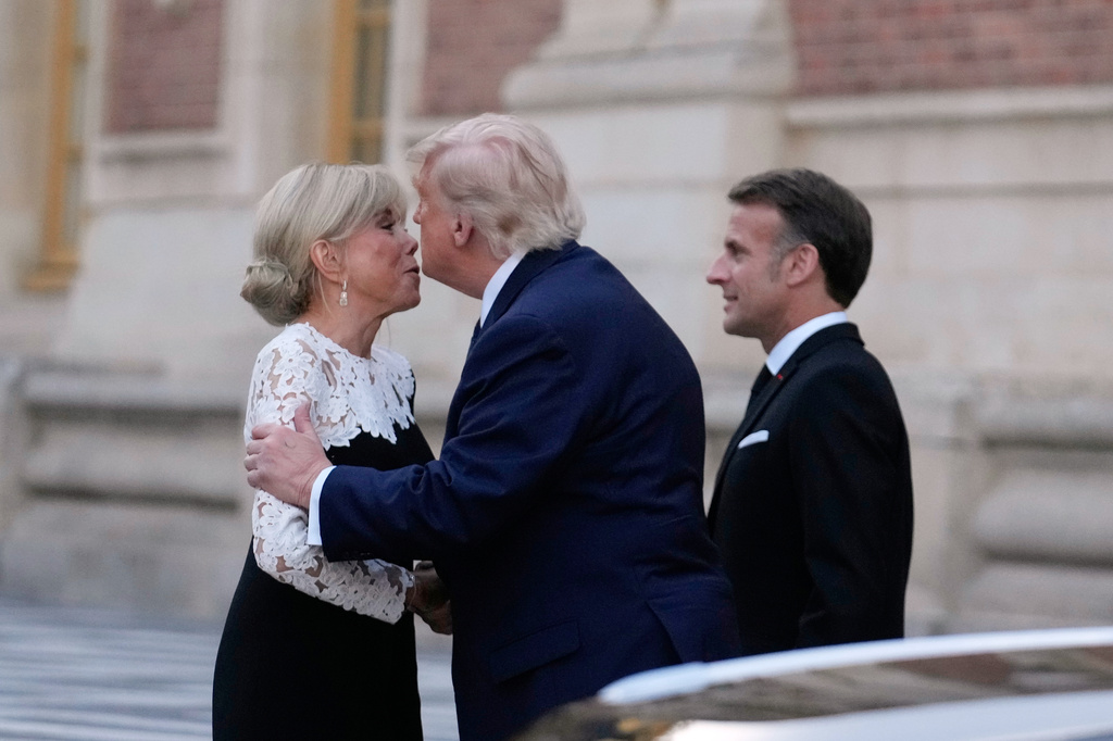 France's President Emmanuel Macron, right, and his wife Brigitte greet U.S. President Donald Trump before a private dinner to celebrate the USA's 250th birthday, at the Palace of Versailles, outside Paris, Wednesday, June 17, 2026. (AP Photo/Michel Euler)