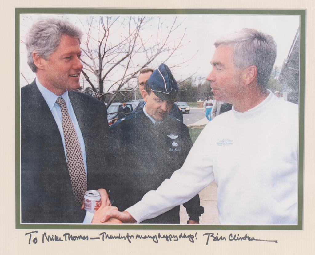 An inscribed photo of President Bill Clinton with Michael Thomas, the former manager of the Courses at Andrews at Joint Base Andrews, is seen Friday, Dec. 19, 2025, in Lothian, Md. (Michael Thomas via AP)